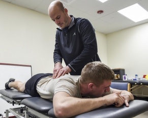 physical therapist working on patient's back