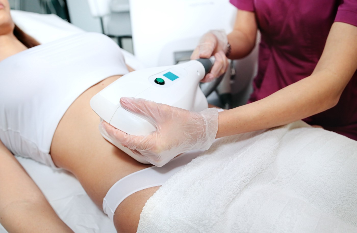 woman receiving coolsculpting procedure; cosmetic fat loss procedure
