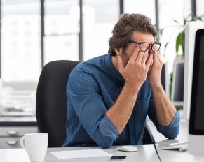 Person resting and looking exhausted, why you’re always tired and causes of fatigue